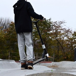 Man with a scooter at the skate park